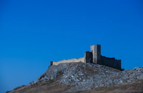 Medieval Albanian castle ruins under a bright blue sky