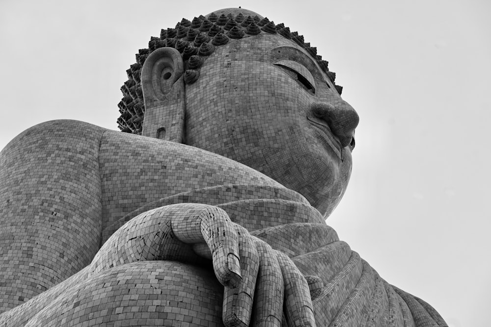 a black and white photo of a buddha statue