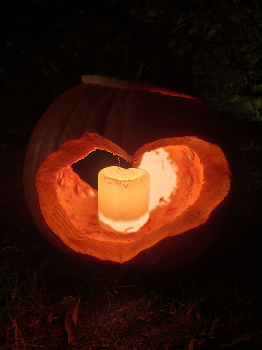 a candle is lit inside of a carved pumpkin