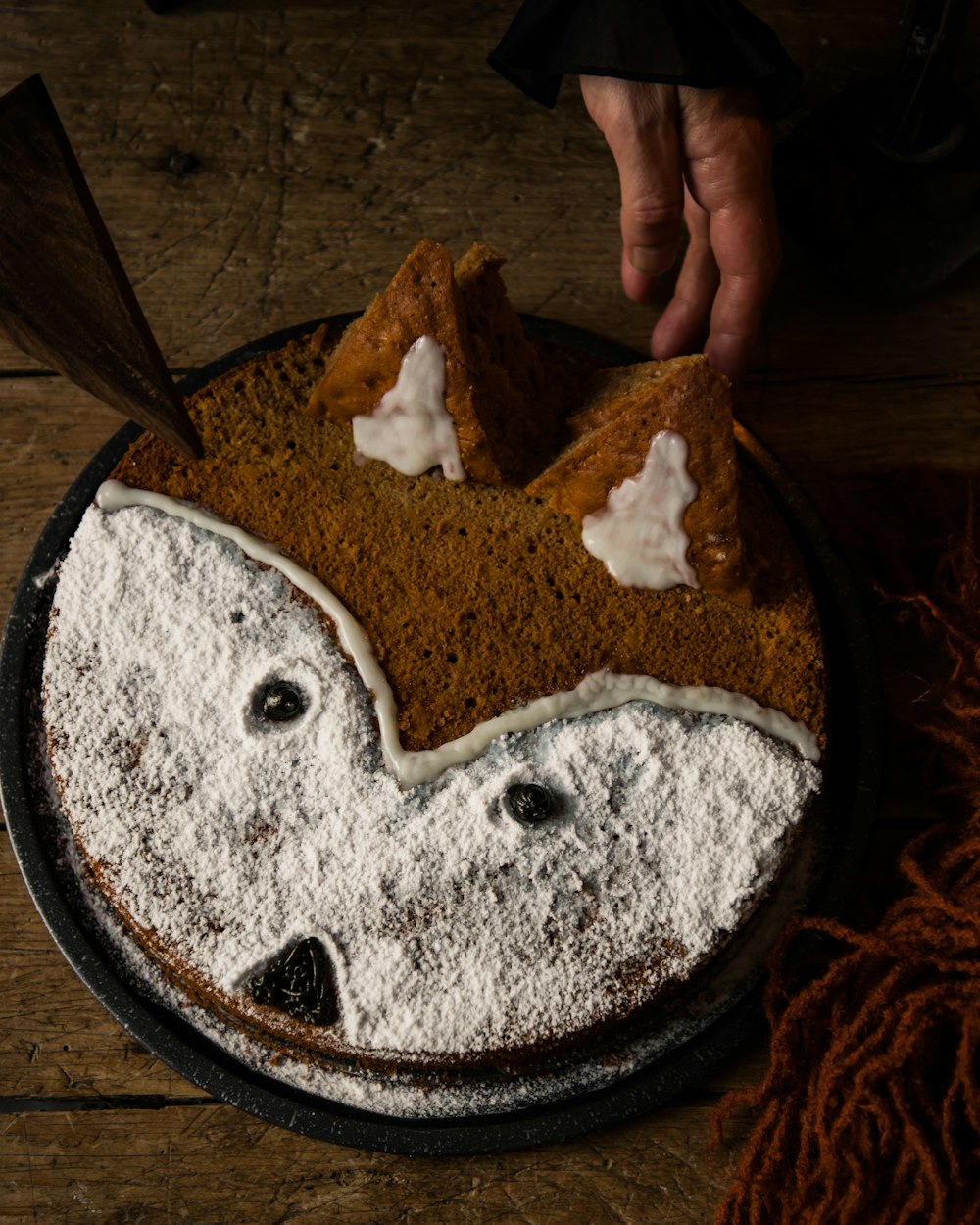 a cake with a face made of powdered sugar