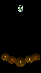 Close-up of a grungy patch featuring a glowing green jack-o'-lantern stitched with vibrant thread.