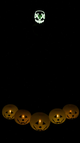 Close-up of a grungy patch featuring a glowing green jack-o'-lantern stitched with vibrant thread.