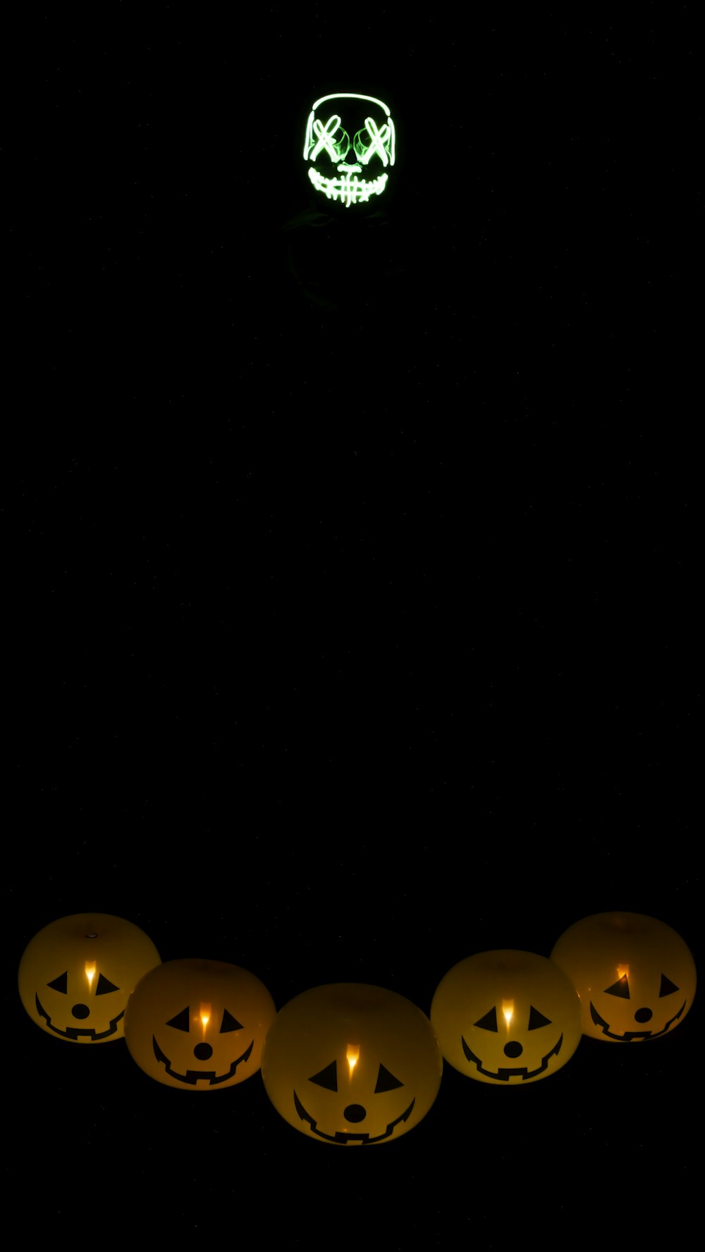 a group of pumpkins sitting in the dark