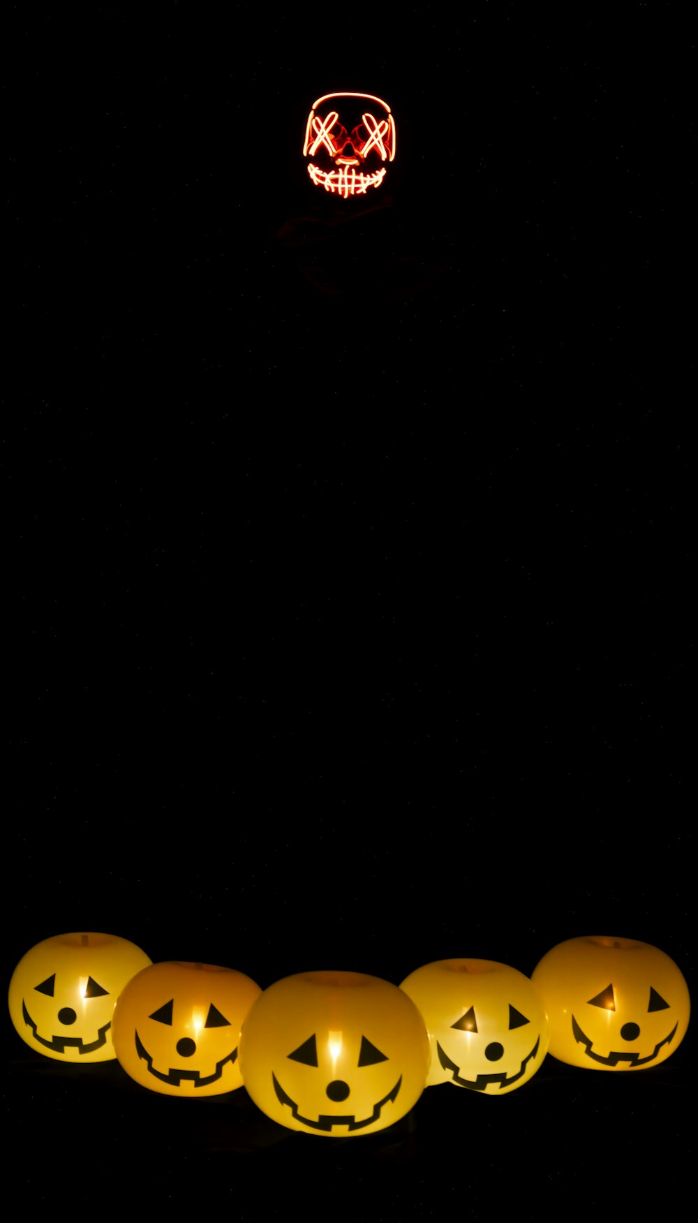 a group of pumpkins sitting in the dark