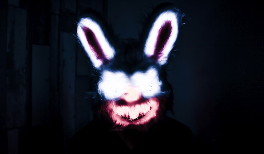 a person wearing a bunny mask in the dark