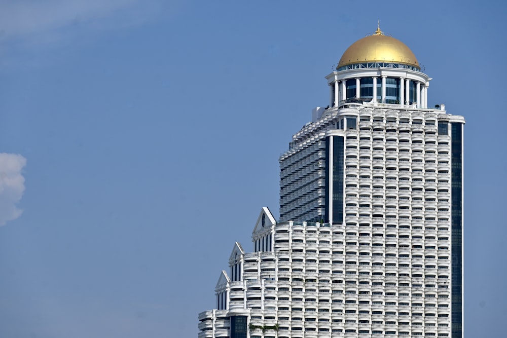 a tall white building with a gold dome on top