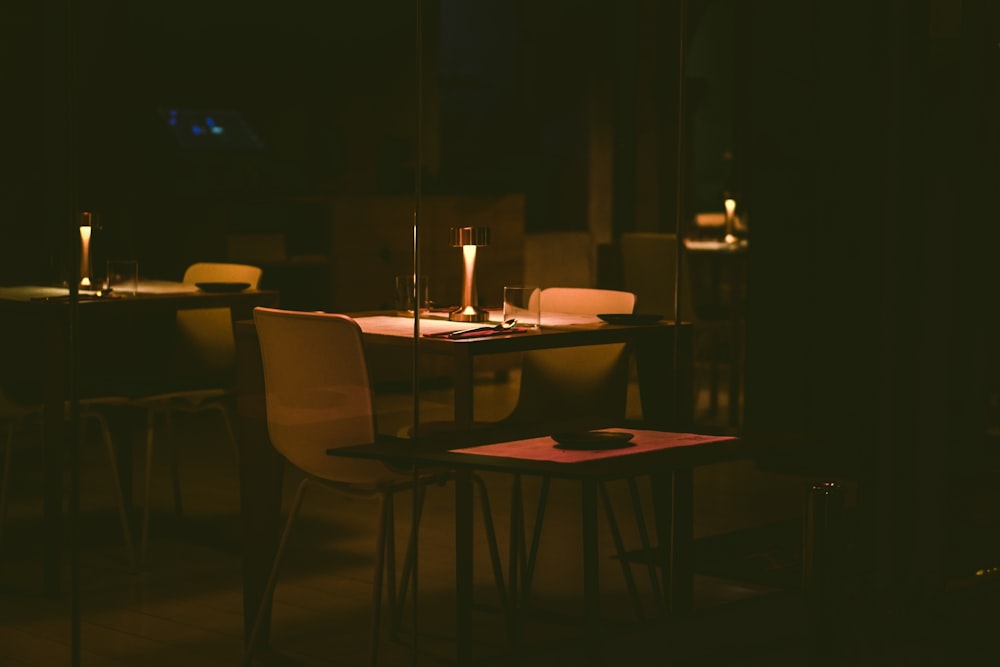 a dimly lit table and chairs in a dark room