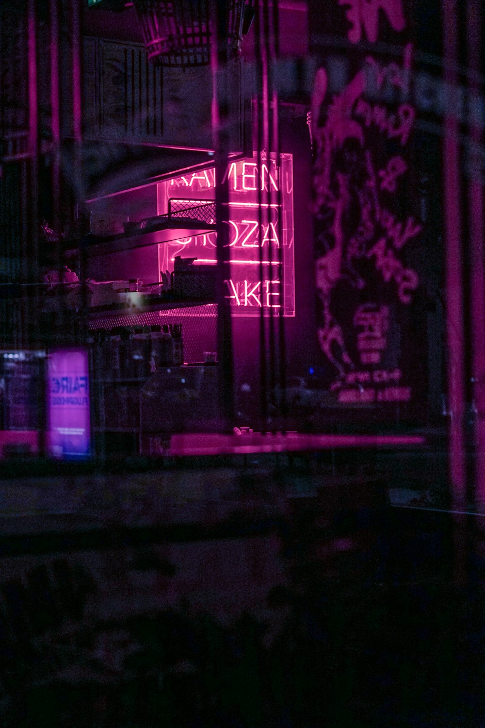 a neon sign is lit up in the dark