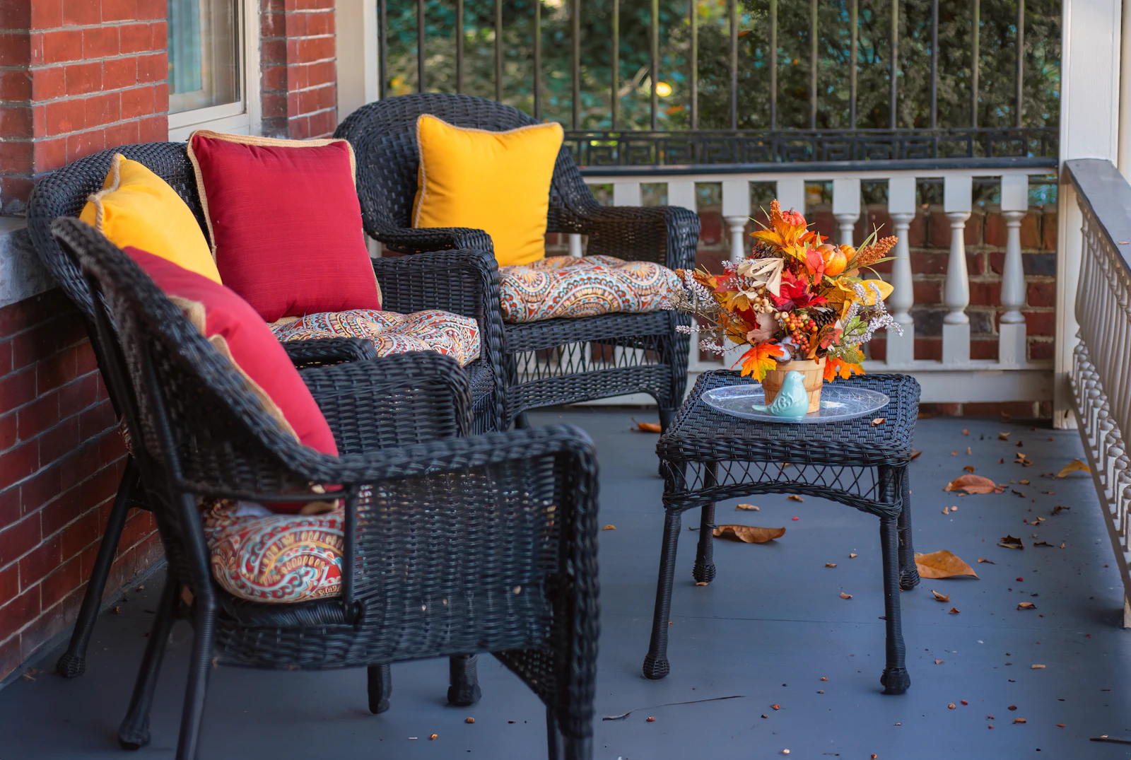 Two wicker chairs on a quiet front porch
