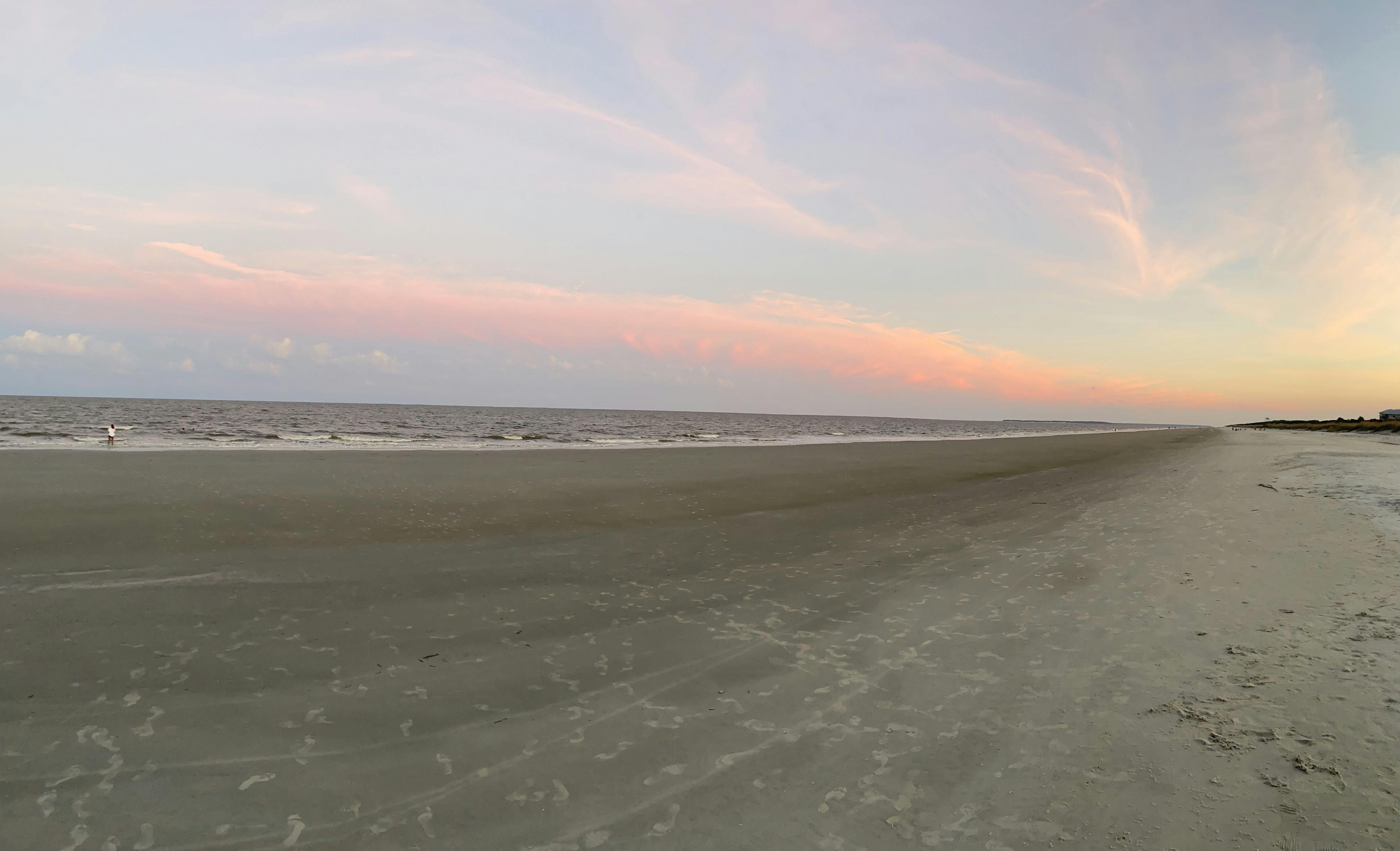 a sandy beach with footprints in the sand