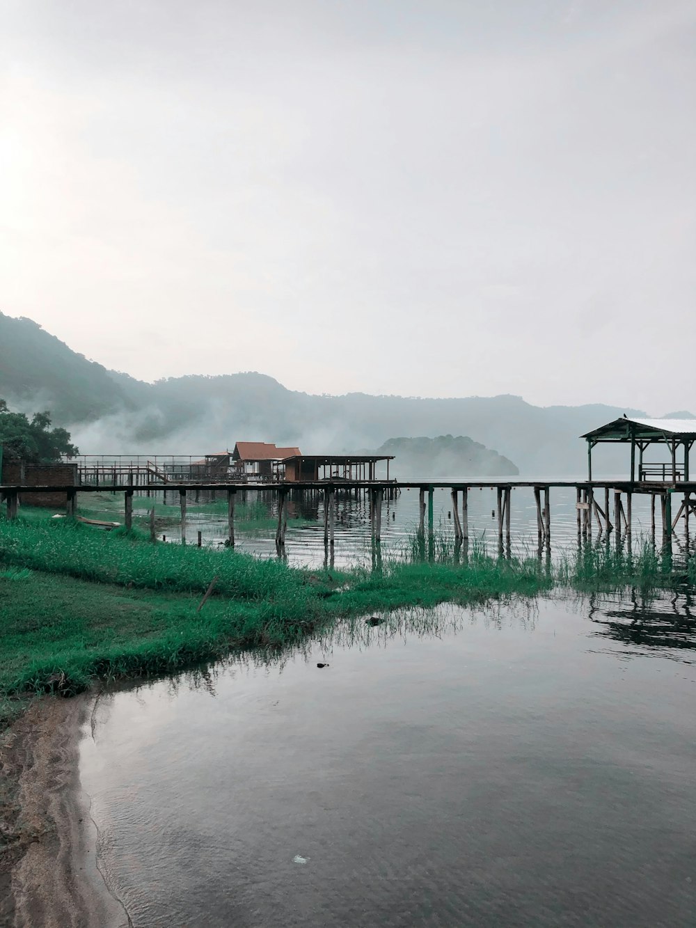 a body of water with a dock in the middle of it