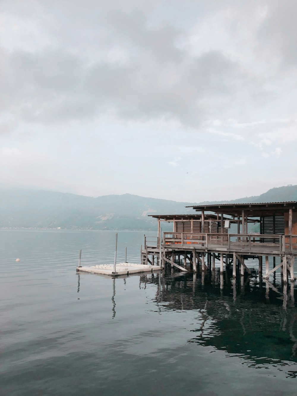 a dock with a house on it in the middle of the water