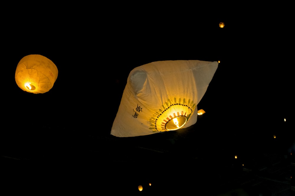 a couple of paper lanterns floating in the air