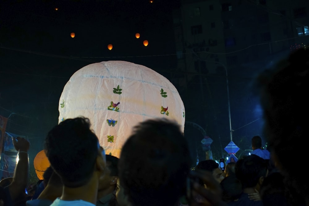 a group of people standing around a giant balloon