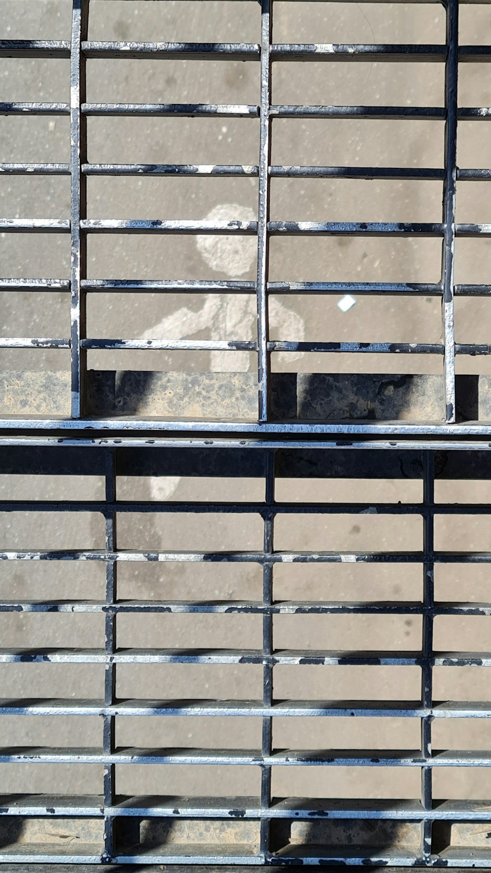 a black and white cat sitting on top of a metal fence