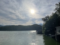 A sparkling clean lakeside home with sunlight reflecting on the windows.