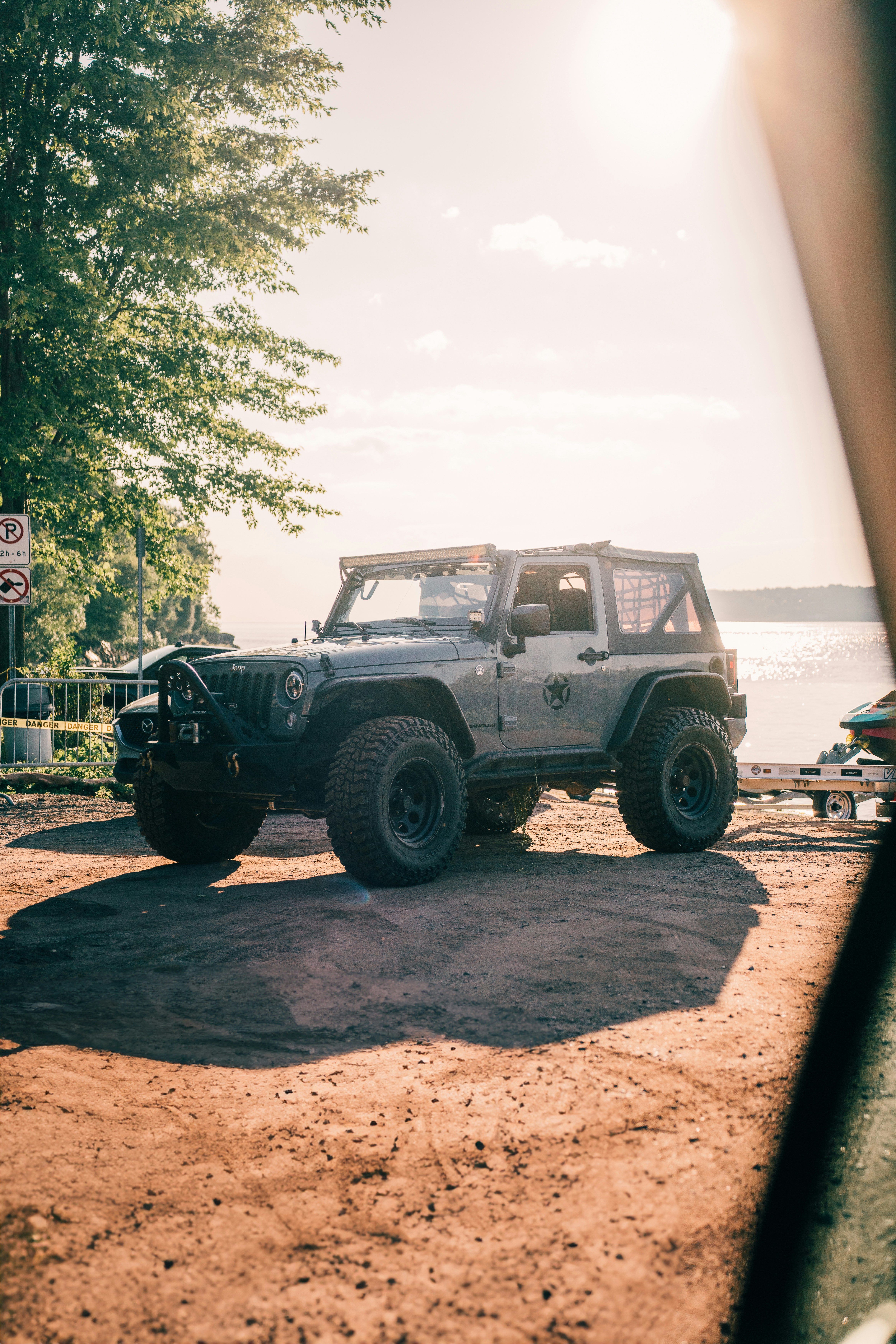 a jeep parked on the side of a dirt road