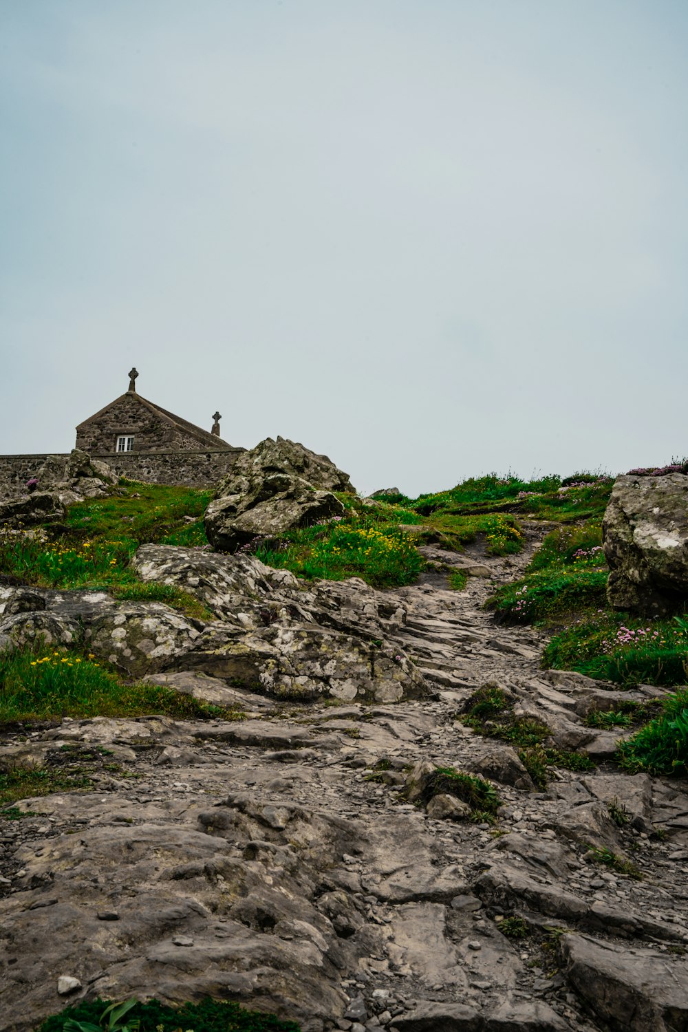 a small building on top of a rocky hill