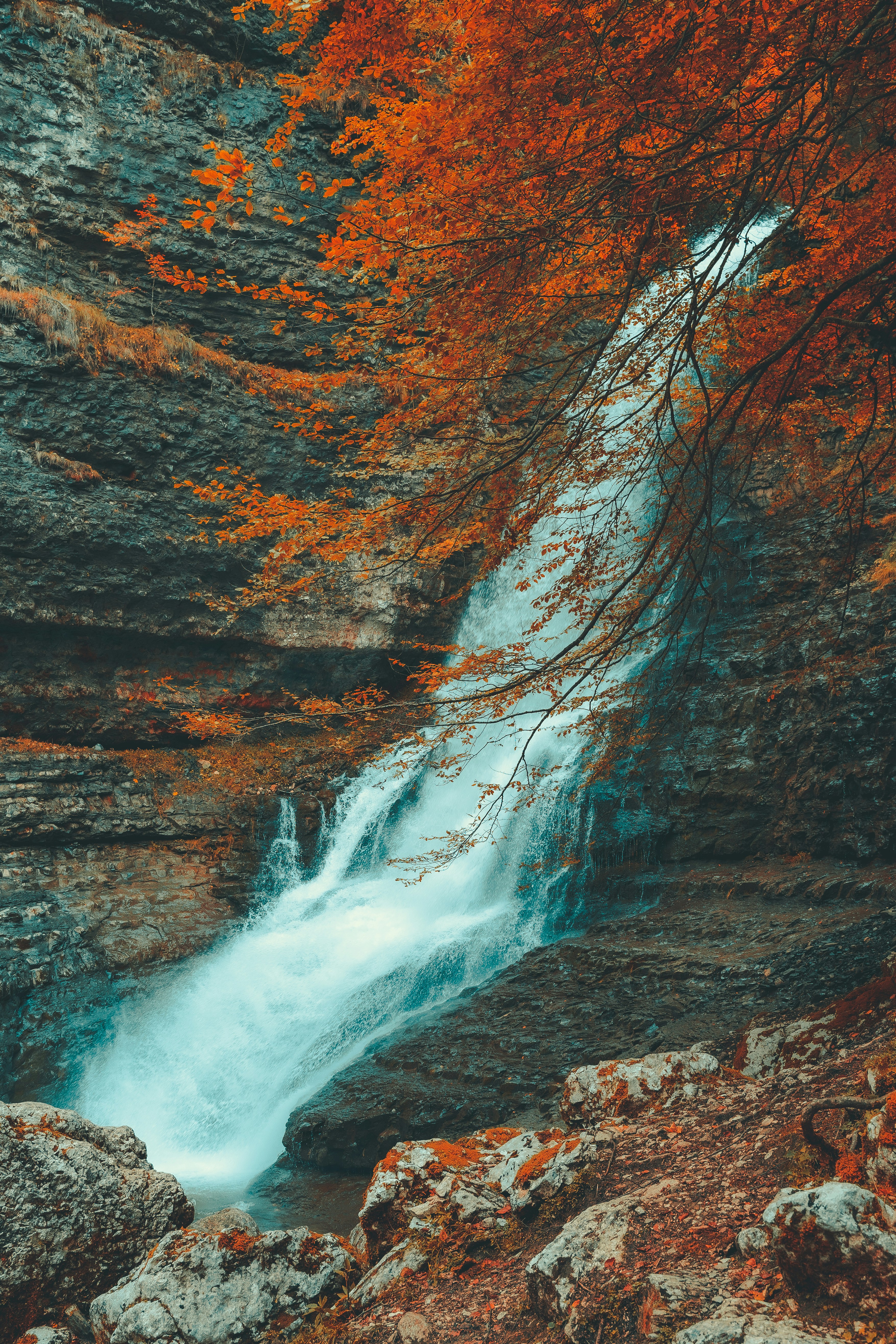 a waterfall in the middle of a rocky area