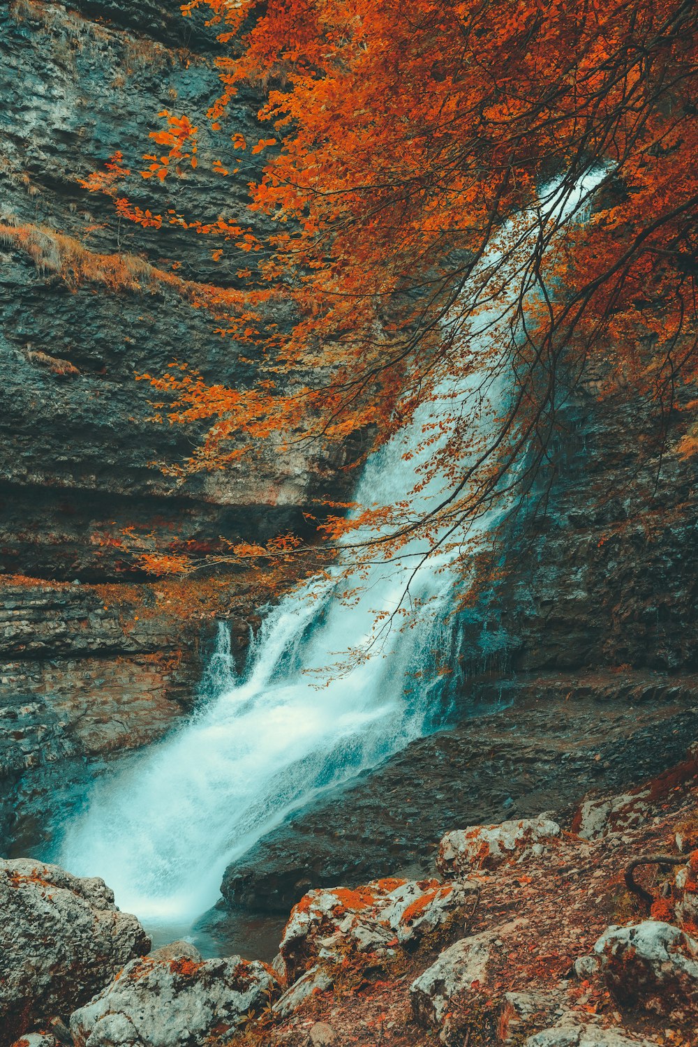 a waterfall in the middle of a rocky area