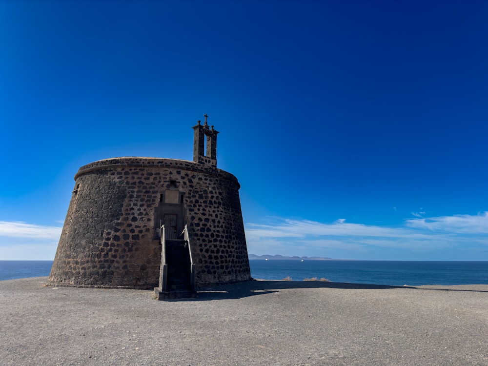 a stone tower with a clock on the top of it