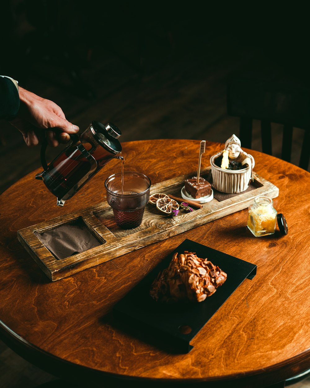 a wooden table topped with pastries and drinks