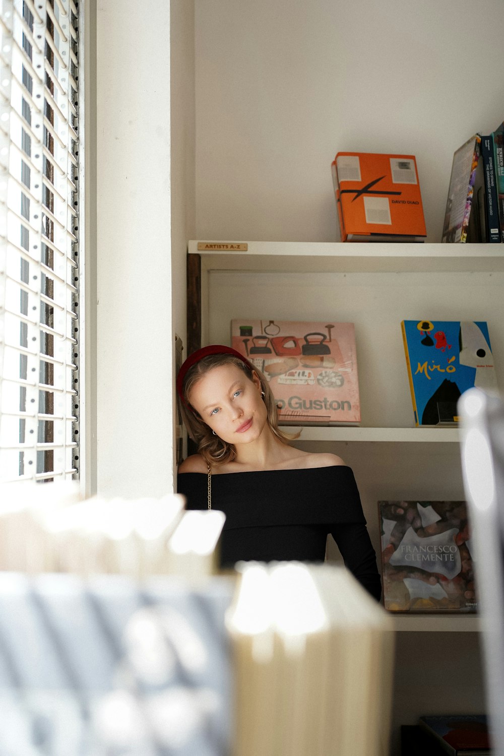 a woman in a black top sitting in a room