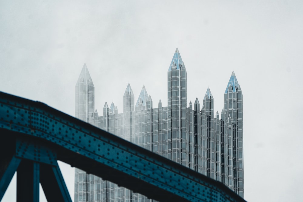 a view of a very tall building from across a bridge