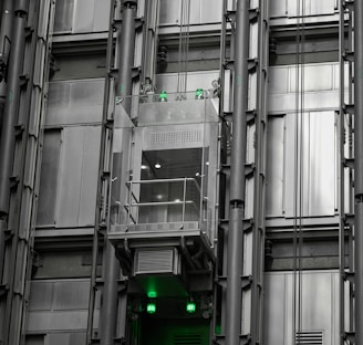 a tall building with lots of windows and green lights