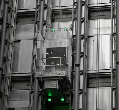 a tall building with lots of windows and green lights
