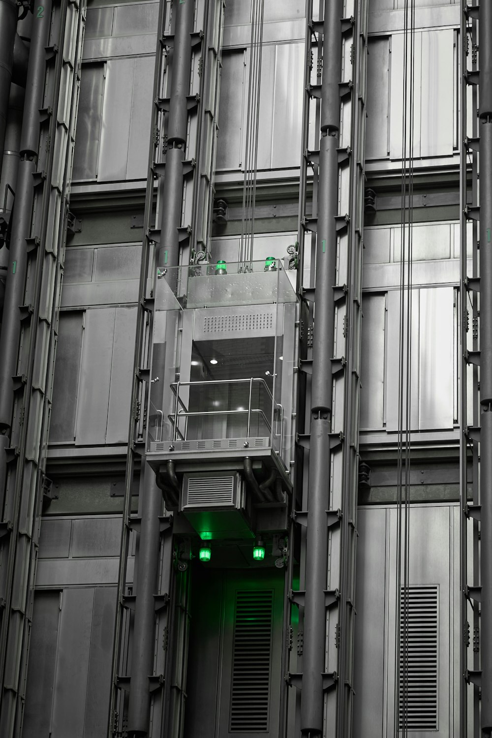 a tall building with lots of windows and green lights
