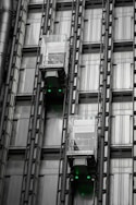a tall building with lots of windows and green lights