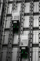 a tall building with lots of windows and green lights