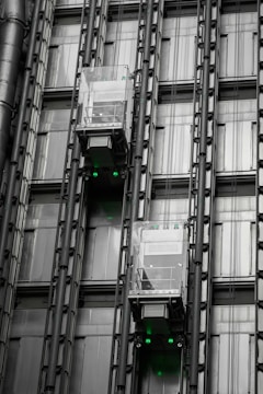 a tall building with lots of windows and green lights