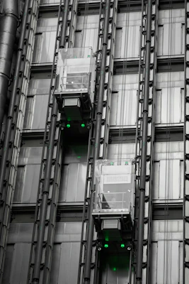 a tall building with lots of windows and green lights