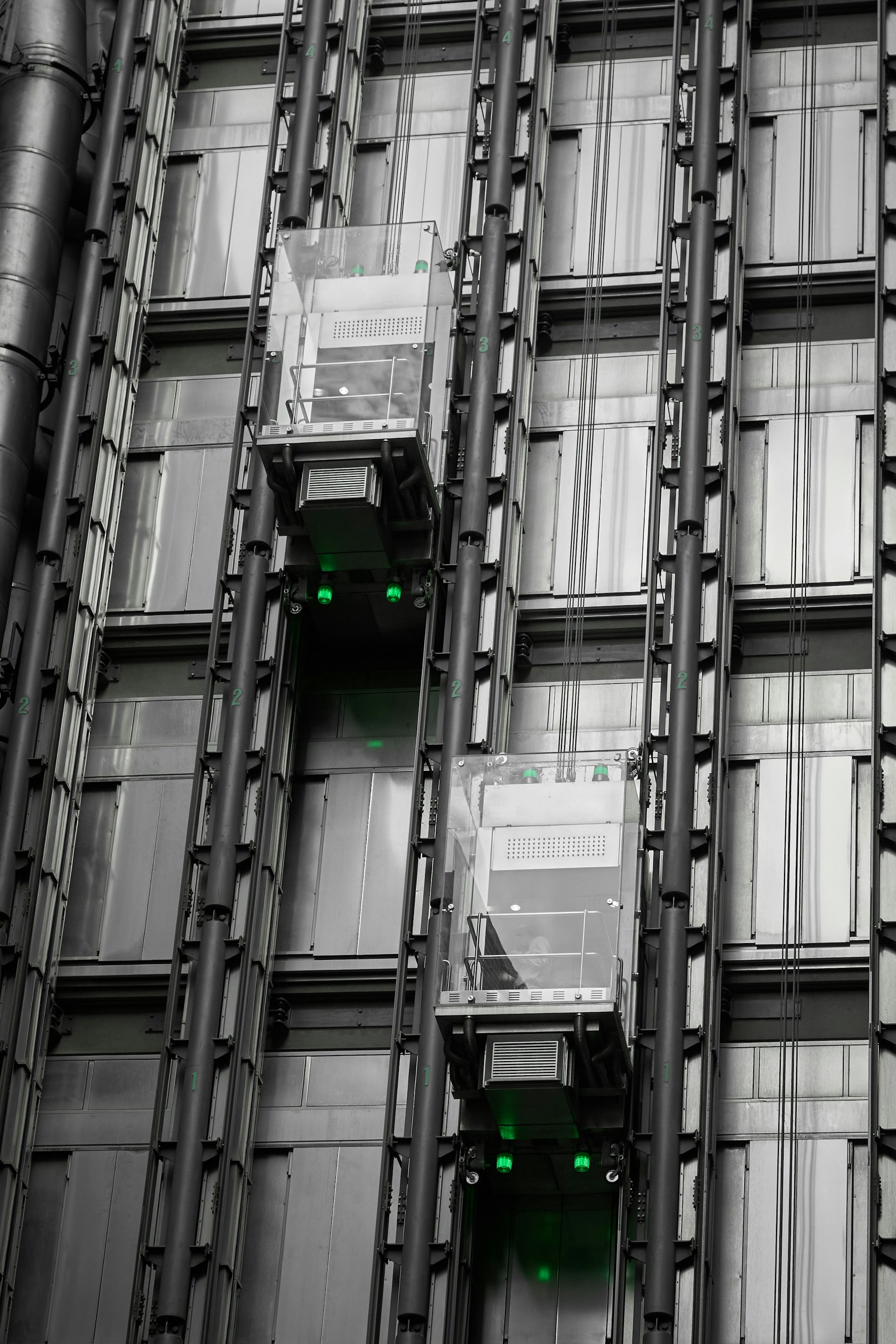 a tall building with lots of windows and green lights