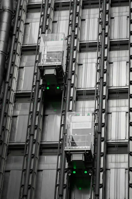 a tall building with lots of windows and green lights