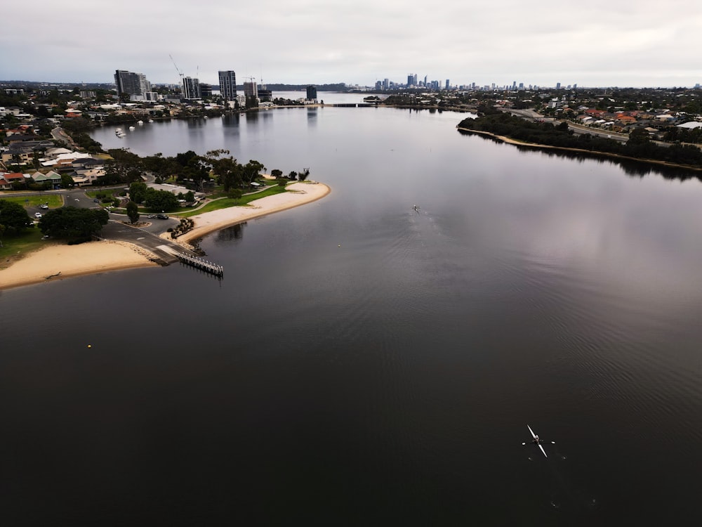 a body of water with a city in the background