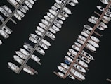 Aerial view of several yachts docked at a vibrant Miami marina.