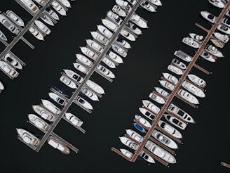 An aerial view of a fleet of yachts in a marina.