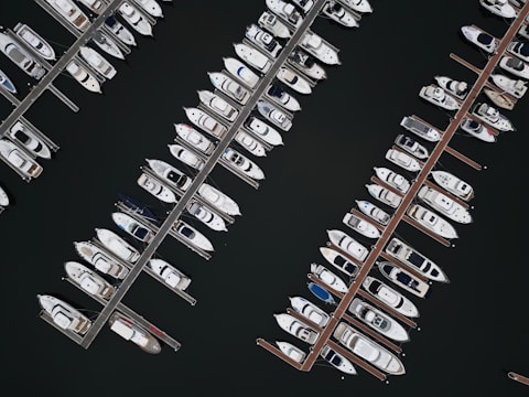 A panoramic view of well-maintained boats in a marina.