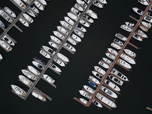 An aerial view of a fleet of yachts in a marina.