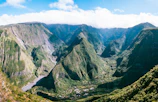 a view of a valley with mountains in the background