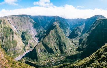 a view of a valley with mountains in the background