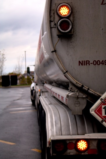 a large tanker truck with a red light on it's side