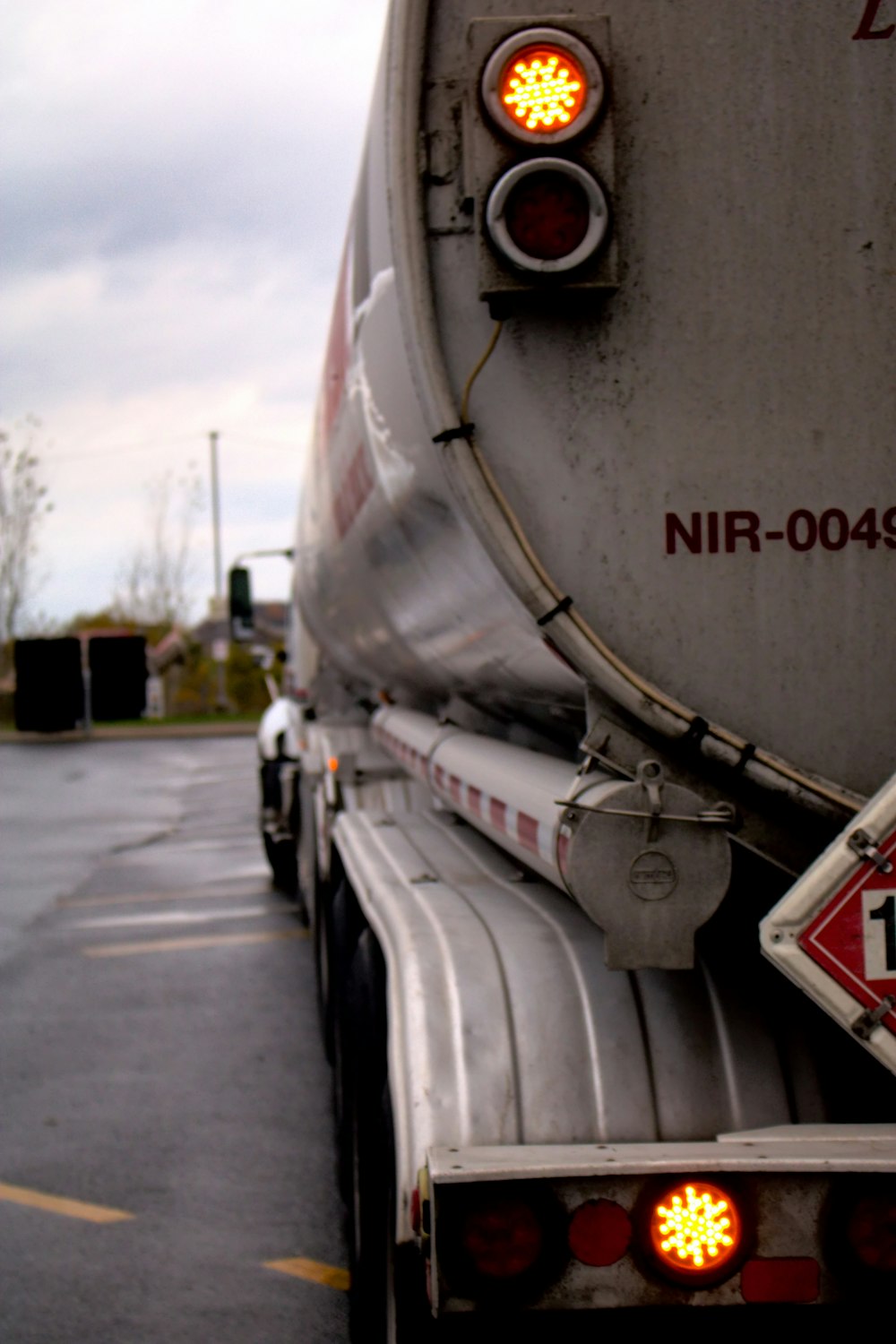 a large tanker truck with a red light on it's side