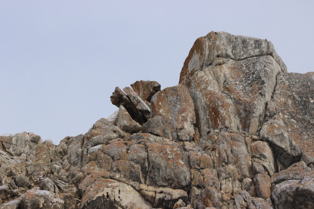 a large rock formation with a sky background