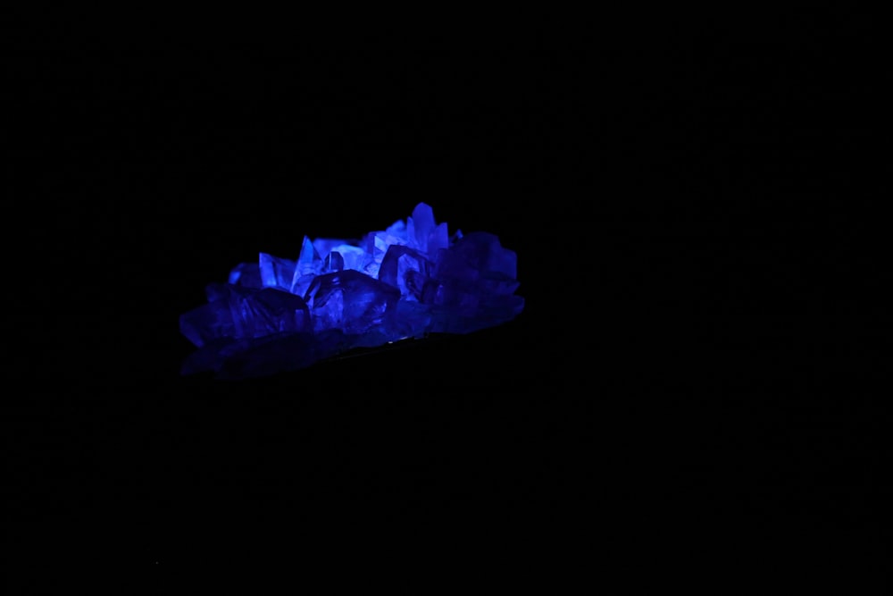 a group of blue rocks in the dark