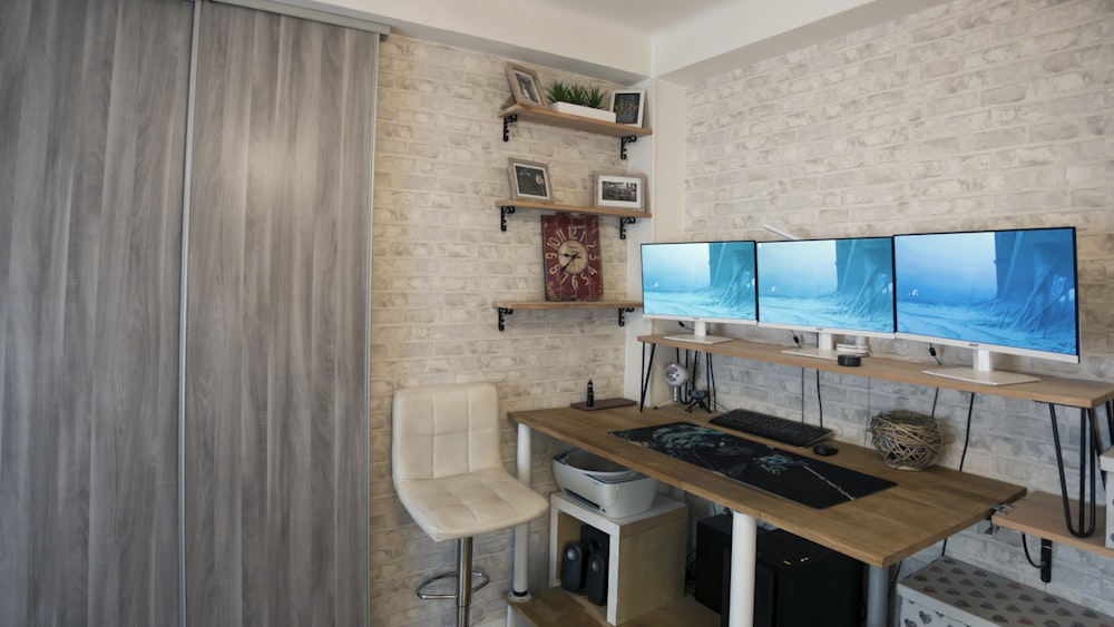 a computer desk with two monitors on top of it