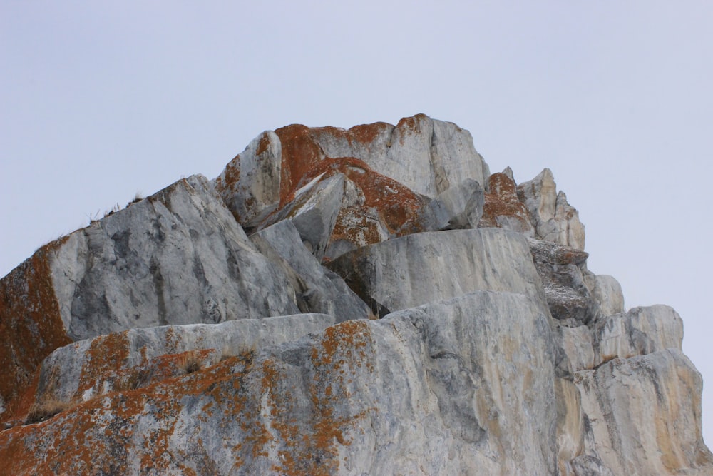 a large rock formation with a bird perched on top of it